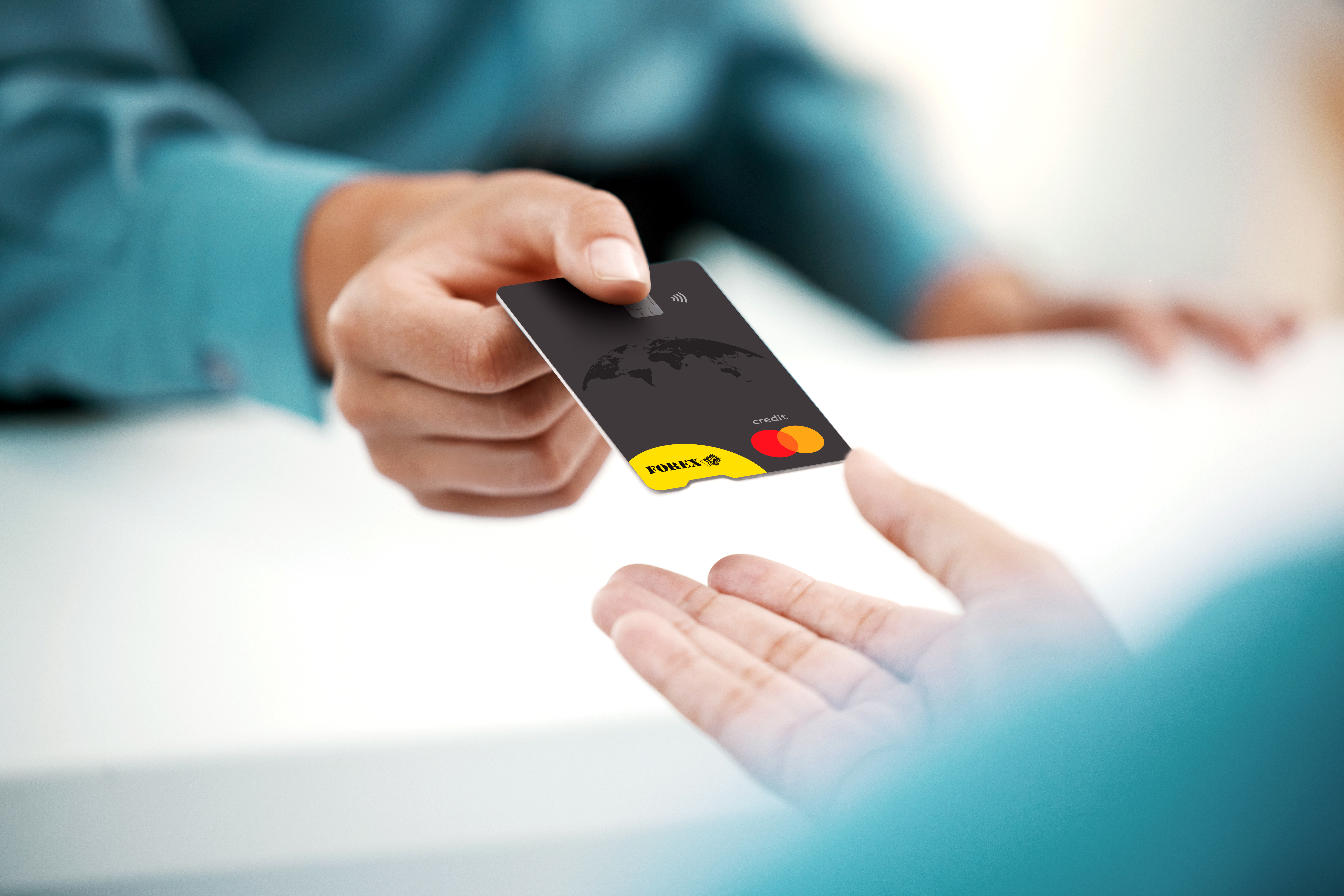 Person hands over a black credit card with Mastercard logo to another person, focused on contactless payment.