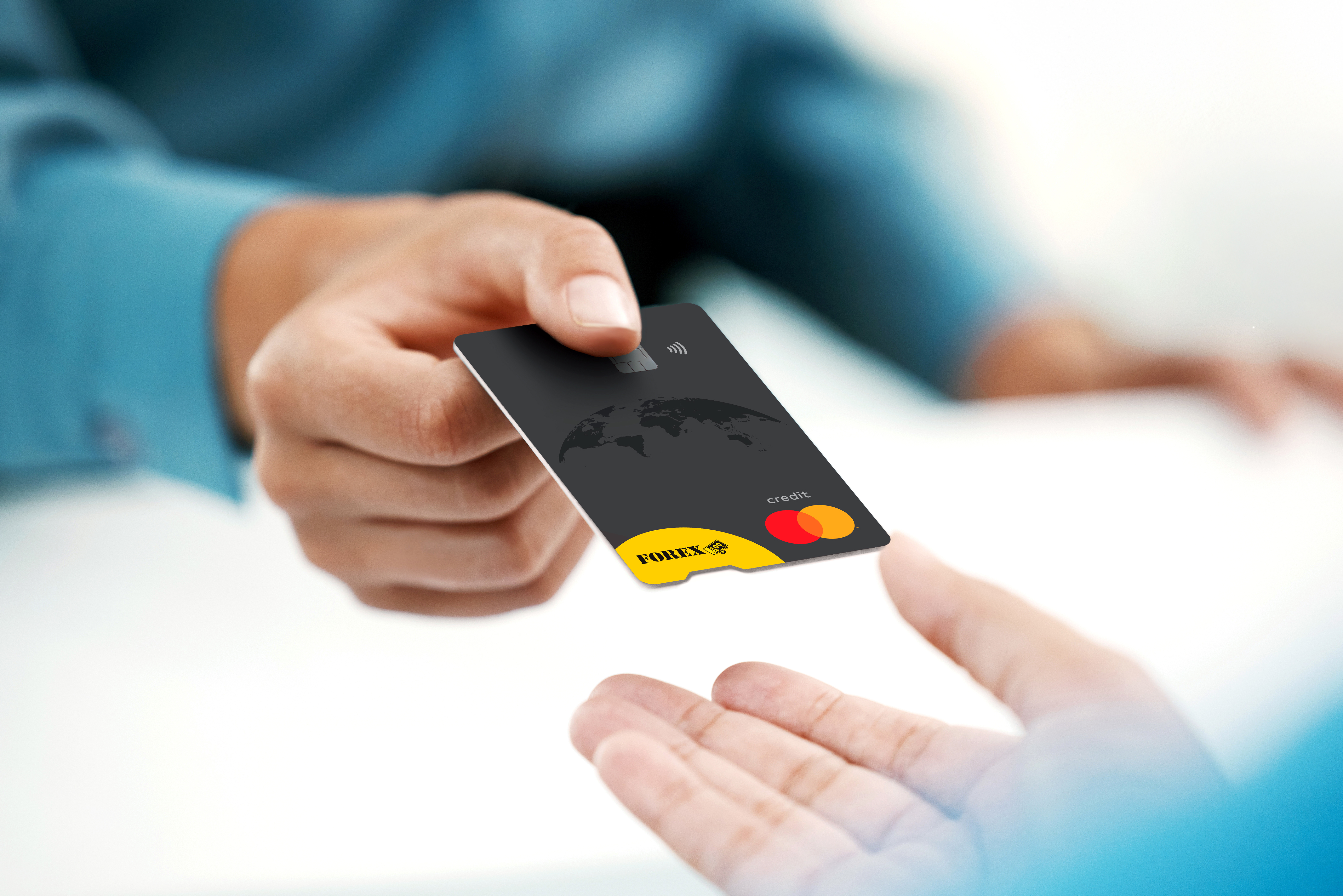 Person hands over a black FOREX credit card in close-up.