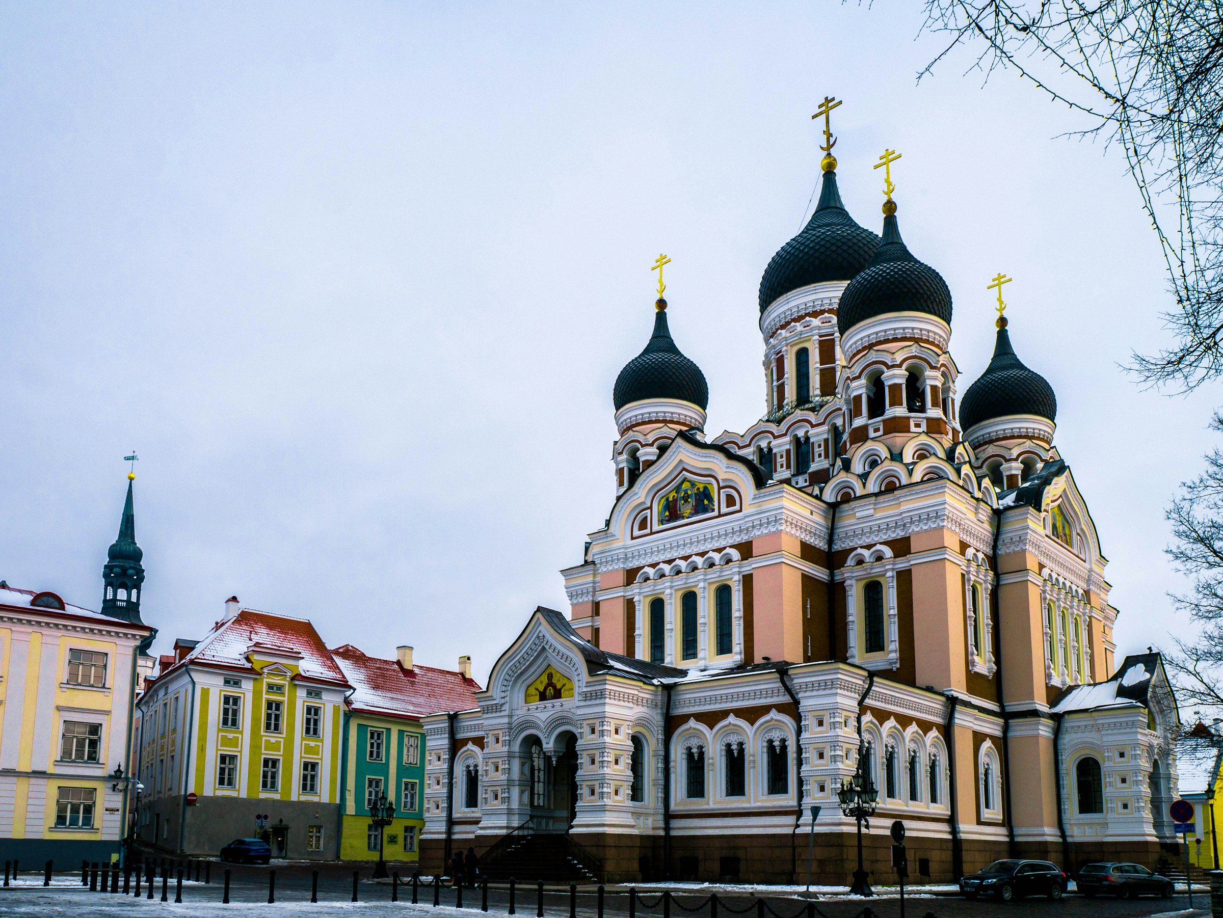 Tallinn, Estonia's Alexander Nevsky Cathedral, showcasing its striking Russian Revival architecture, adorned with iconic onion domes, against a clear sky.