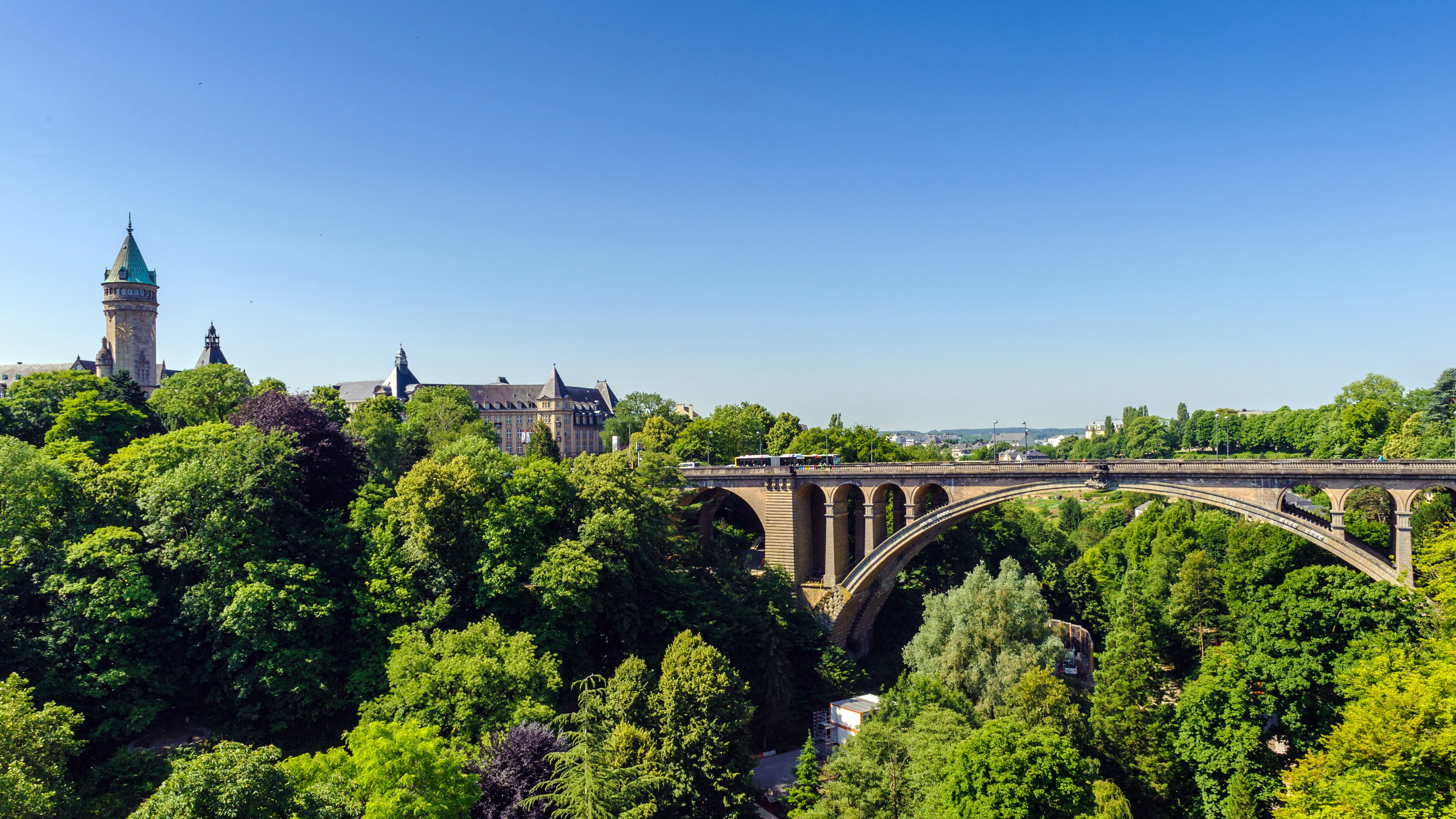Luxembourg Cityscape with Adolphe Bridge and Lush Greenery in Summer