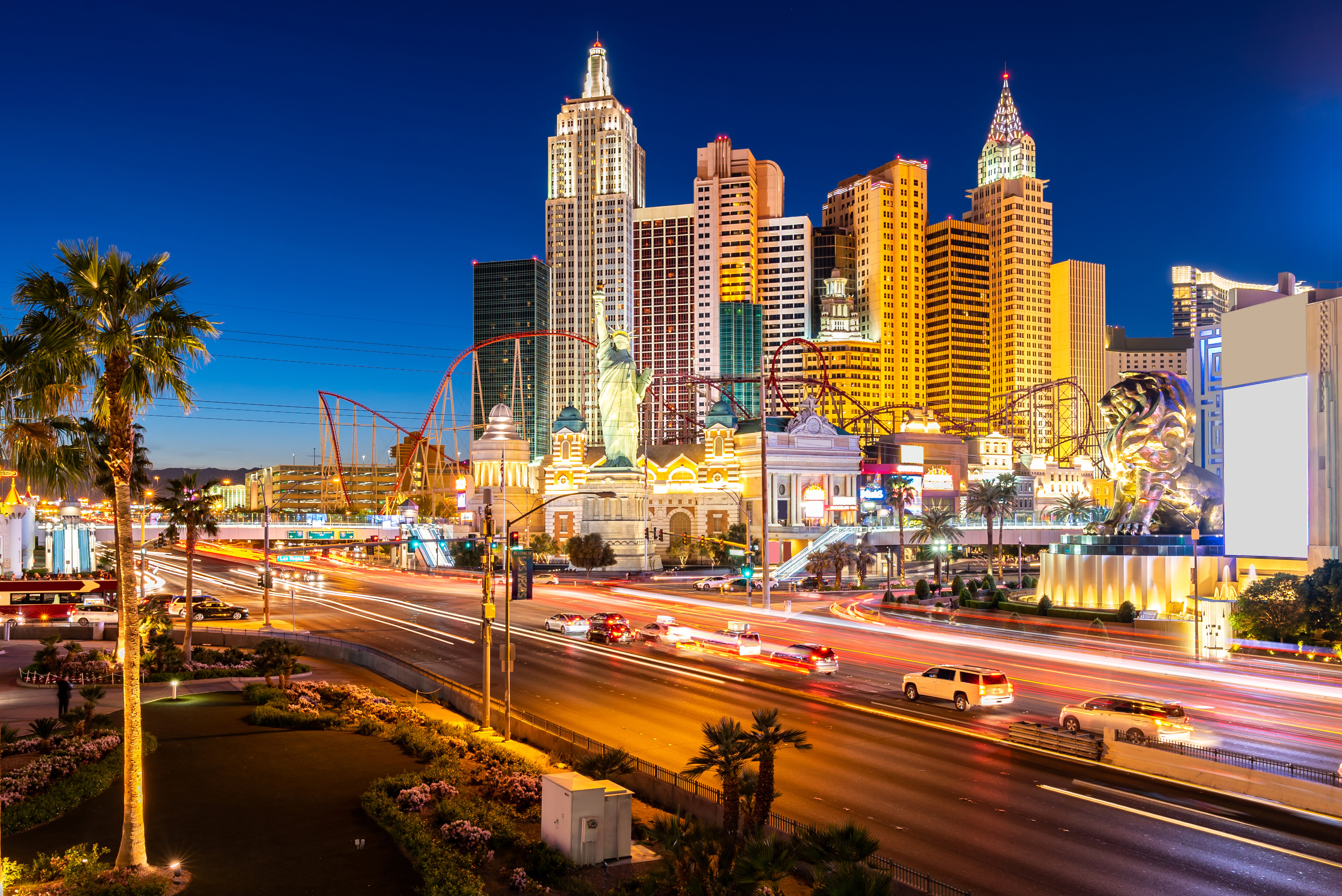 Las Vegas Strip at night featuring illuminated hotels, casinos, and traffic, with a view of iconic architecture and vibrant cityscape